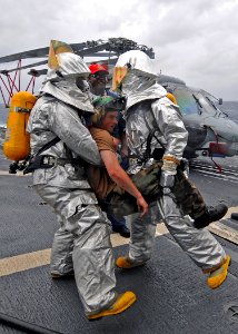 US Navy 080902-N-1082Z-020 Sailors assist an injured shipmate during casualty drills held aboard the guided-missile cruiser USS Vella Gulf (CG 72)