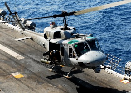 US Navy 080902-N-2183K-125 A UH-1N Twin Huey helicopter carefully lands aboard the amphibious assault ship USS Peleliu (LHA 5) photo