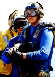 US Navy 080905-N-2183K-051 A nozzle team fights a simulated fire during a flight deck fire drill aboard the amphibious assault ship USS Peleliu (LHA 5)