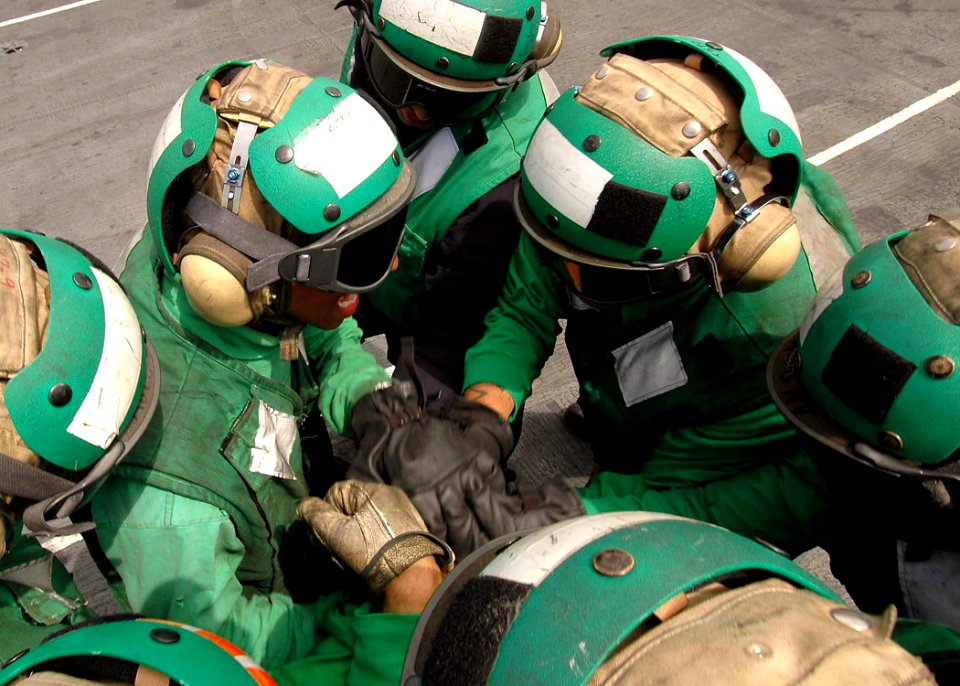 US Navy 080829-N-7282P-019 Sailors assigned to the Air Department of the aircraft carrier USS George Washington (CVN 73) huddle to motivate one another before the start of flight operations