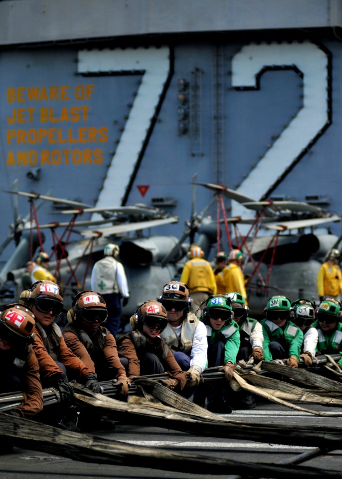 US Navy 080904-N-7981E-115 Flight deck personnel rig barricades during a drill aboard Nimitz-class aircraft carrier USS Abraham Lincoln (CVN 72)