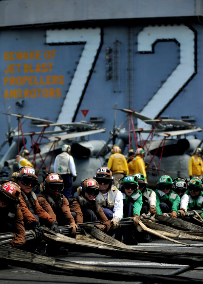 US Navy 080904-N-7981E-115 Flight deck personnel rig barricades during a drill aboard Nimitz-class aircraft carrier USS Abraham Lincoln (CVN 72) photo