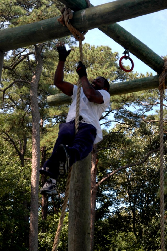 US Navy 080903-N-9095H-134 Equipment Operator 1st Class Robert Young, assigned to Navy Expeditionary Combat Command (NECC), smiles as he finishes the rope climb event during the NECC's inaugural Toughman Competition