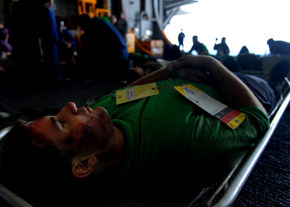 US Navy 080904-N-9079D-199 A simulated casualty waits to be assisted during a mass casualty drill aboard the Nimitz-class aircraft carrier USS Abraham Lincoln (CVN 72)