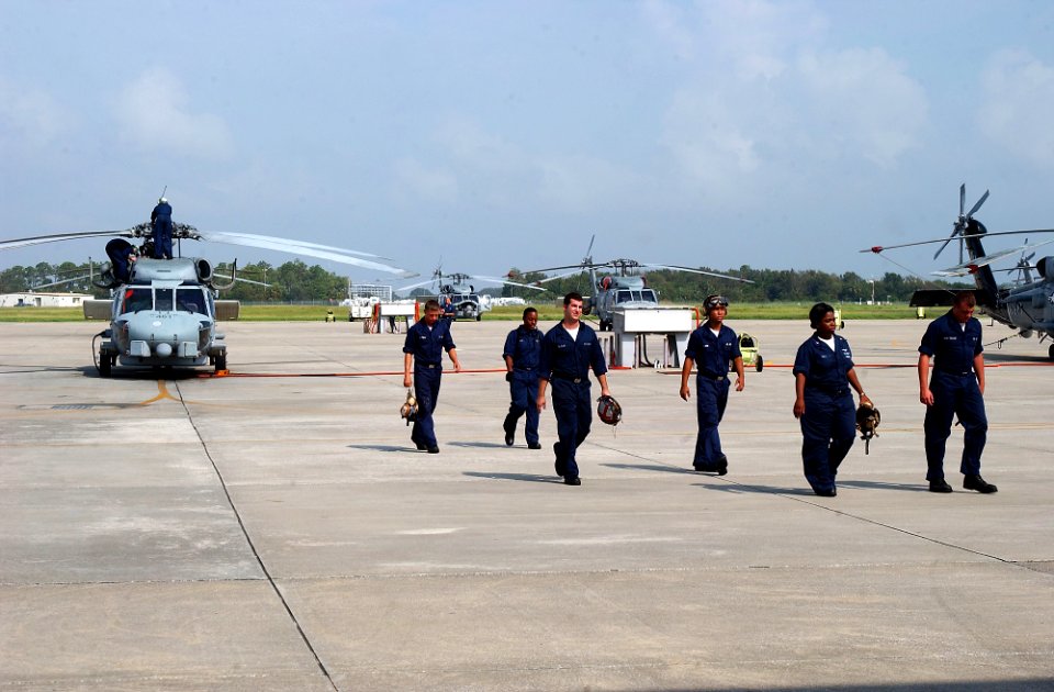 US Navy 080902-N-1522S-005 A helicopter crewreturns from performing maintenance on a helicopter