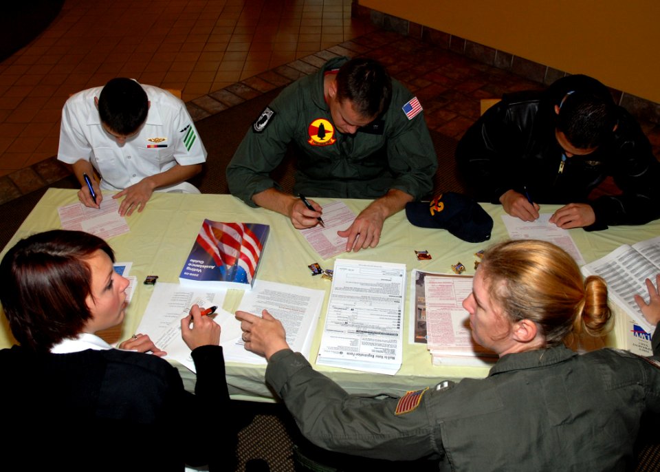 US Navy 080904-N-9860Y-002 Aviation Electronics Technician 3rd Class Alicia Wren, assigned to NAS Whidbey Island, left, and Lt. Laura Reeves, the Naval Air Station Whidbey Island voting assistance officer, help Sailors register