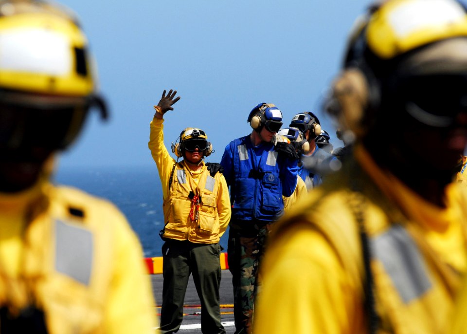 US Navy 080905-N-2183K-052 A nozzle team fights a simulated fire during a flight deck fire drill aboard the amphibious assault ship USS Peleliu (LHA 5)