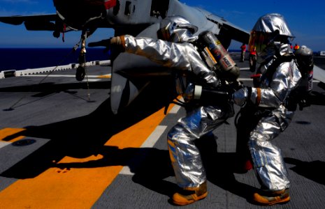 US Navy 080902-N-1688B-260 Aviation boatswain's mates search for a simulated fire during a firefighting and personnel rescue training held on the flight deck of the multi-purpose amphibious assault ship USS Bataan (LHD 5) durin