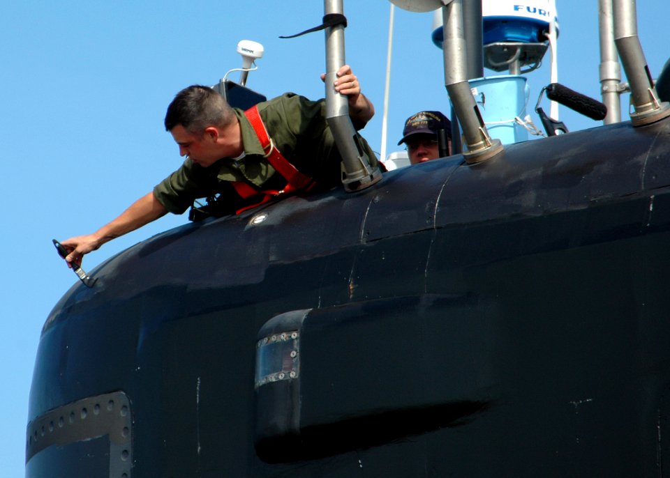 US Navy 080905-N-7705S-001 Sonar Technician 2nd Class Jacob Stich touches up a fresh coat of paint on the sail of the Virginia class fast-attack submarine USS North Carolina (SSN 777)