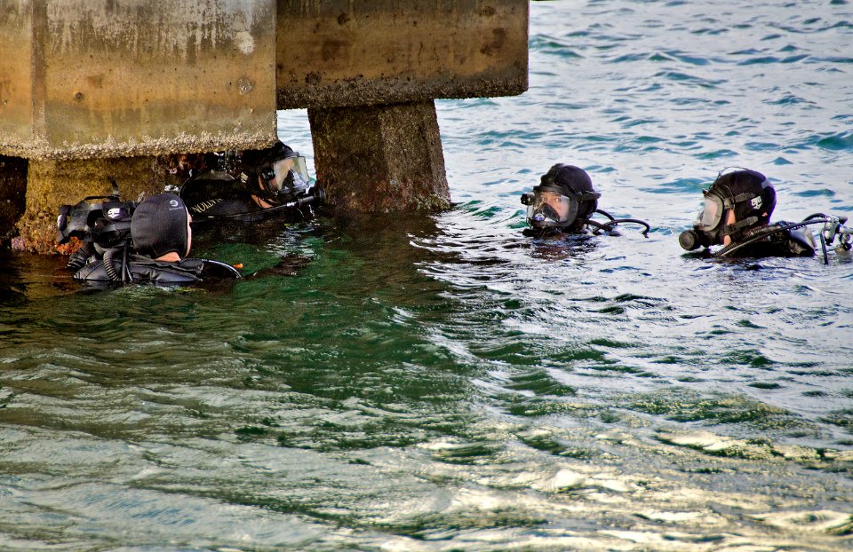 US Navy 111206-N-RI884-236 National Park Service divers participate in a ceremony at the USS Utah Memorial during which Pearl Harbor survivor and U