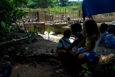 US Navy 080831-N-3595W-176 Local children watch as engineers build a new school house and playground