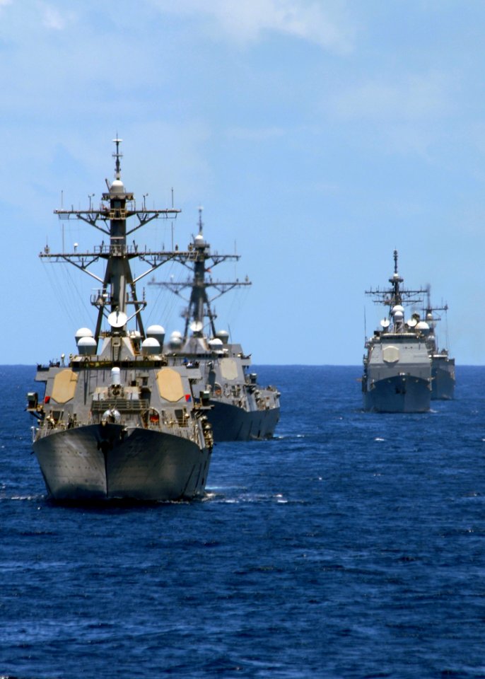 US Navy 080905-N-9079D-409 The Arleigh Burke-class guided-missile destroyer USS Russell (DDG 59) take part in a photo exercise alongside the aircraft carrier USS Abraham Lincoln (CVN 72)