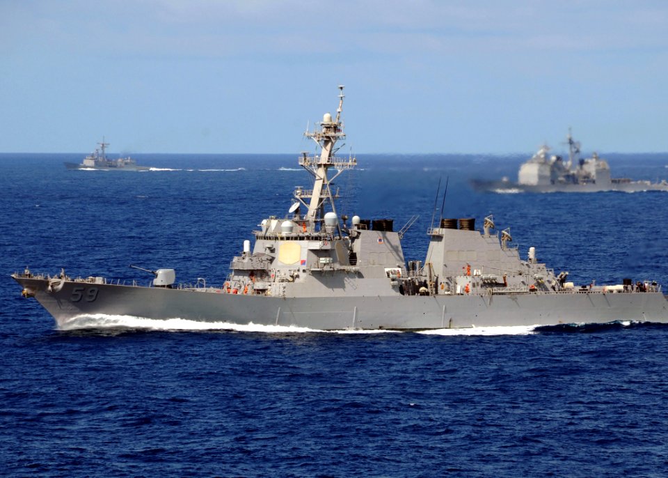 US Navy 080905-N-9898L-019 The Arleigh Burke-class guided-missile destroyer USS Russell (DDG 59) take part in a photo exercise alongside the aircraft carrier USS Abraham Lincoln (CVN 72)
