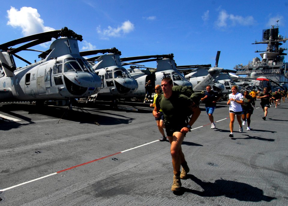US Navy 080906-N-4236E-109 Sailors and Marines participate in a 5k run on the flight deck of the multi-purpose amphibious assault ship USS Iwo Jima (LHD 7)