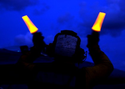 US Navy 080906-N-9898L-364 An aviation boatswain's mate handler from the aircraft carrier USS Abraham Lincoln's (CVN 72) Air Department directs an F-A-18C hornet assigned to the