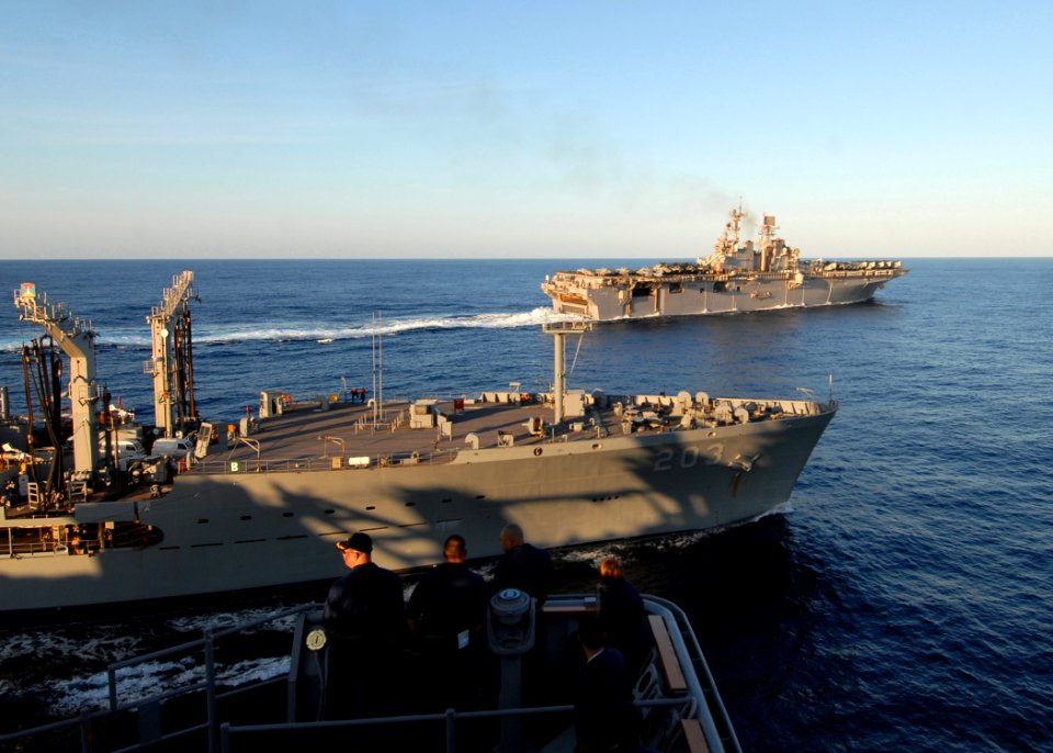 US Navy 080907-N-3392P-216 Sailors aboard the amphibious dock landing ship USS Carter Hall (LSD 50) watch the multi-purpose amphibious assault ship USS Iwo Jima (LHD 7) break away from a replenishment at sea