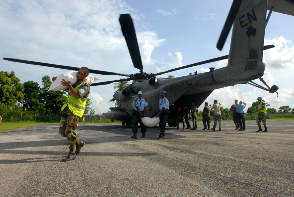 US Navy 080910-N-3595W-462 Military personnel embarked aboard the amphibious assault ship USS Kearsarge (LHD 3) prepare food and water supplies for distribution to areas affected by recent hurricanes that have struck Haiti