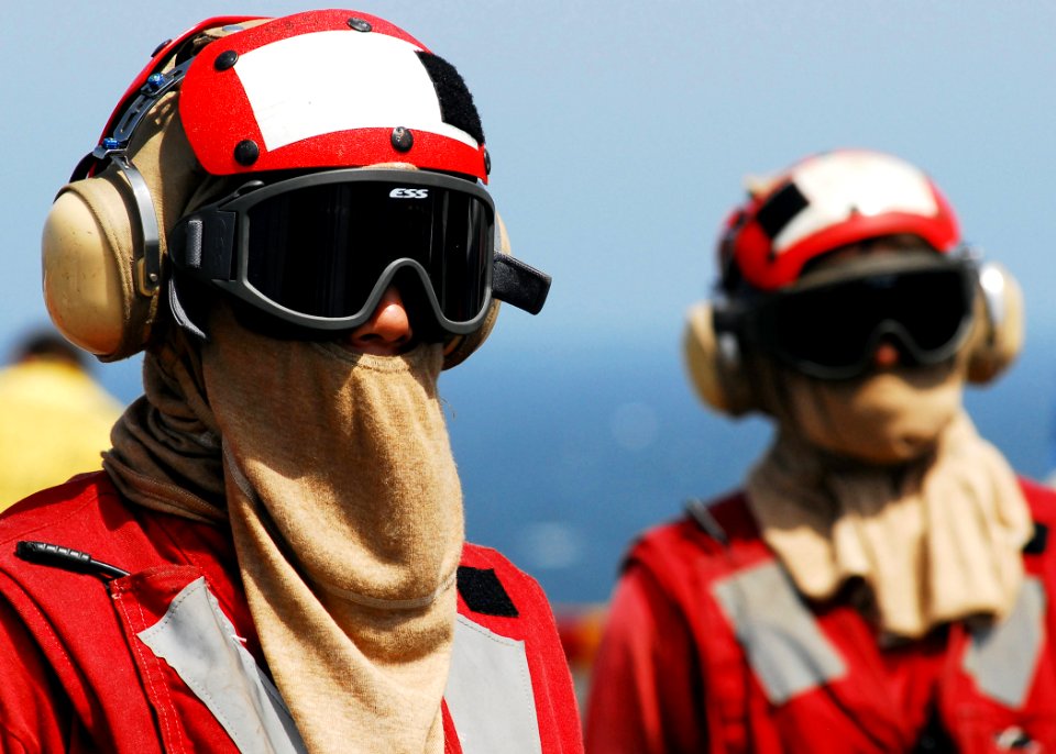 US Navy 080905-N-2183K-073 Members of the crash and salvage team stand by to assist crew members overhaul a simulated fire during a flight deck fire drill aboard the amphibious assault ship USS Peleliu (LHA 5)