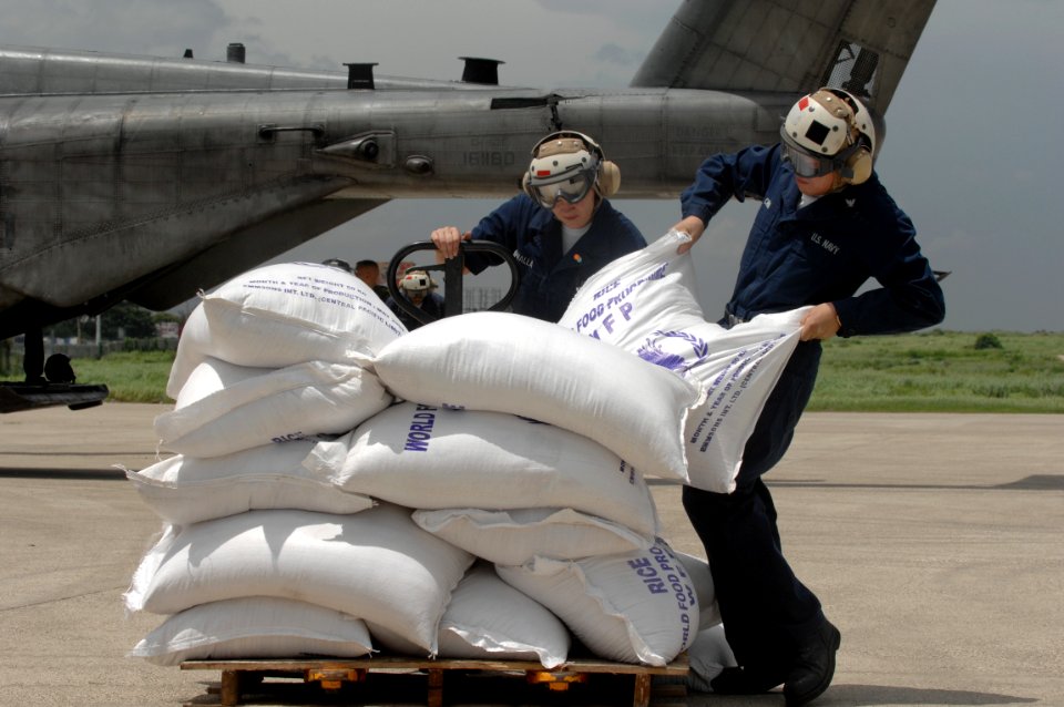US Navy 080909-N-3595W-244 U.S. Navy personnel assigned to the amphibious assault ship USS Kearsarge (LHD 3) unload sacks of food for delivery to citizens affected by the recent hurricanes that have stuck Haiti