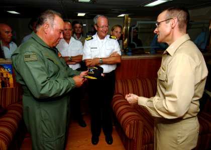 US Navy 080909-N-4236E-306 U.S. Ambassador to Spain The Honorable Eduardo Aguirre receives a ship's cover from Capt. Brian T. Smith, commander of the Iwo Jima Expeditionary Strike Group, during a distinguished visitor tour aboa