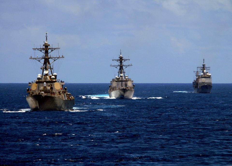 US Navy 080905-N-9079D-440 The Arleigh Burke-class guided-missile destroyer USS Russell (DDG 59) take part in a photo exercise alongside the aircraft carrier USS Abraham Lincoln (CVN 72)