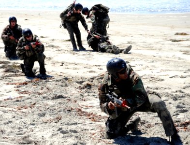 US Navy 080910-N-6552M-194 Crewman Qualification Training (CQT) students provide cover for their teammates in a medical evacuation training scenario at the Naval Special Warfare Center in Coronado