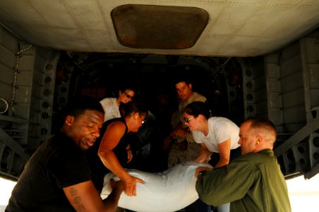 US Navy 080909-N-4515N-472 U.S. military personnel embarked aboard the amphibious assault ship USS Kearsarge (LHD 3) load supplies onto a helicopter to support hurricane relief efforts in Haiti