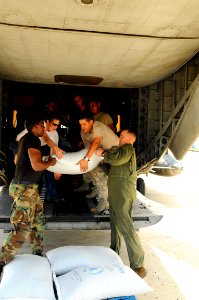 US Navy 080909-N-4515N-491 U.S. military personnel embarked aboard the amphibious assault ship USS Kearsarge (LHD 3) load supplies onto a helicopter to support hurricane relief efforts in Haiti