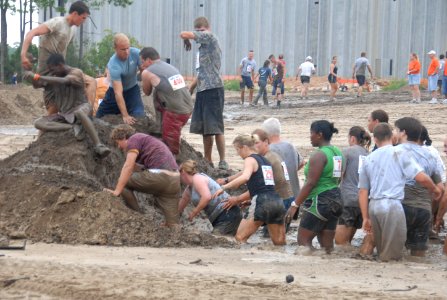 US Navy 080906-N-2468S-004 Participants of the 13th annual Seabee Volkslauf Mud Run complete an obstacle at Naval Construction Battalion Center Gulfport