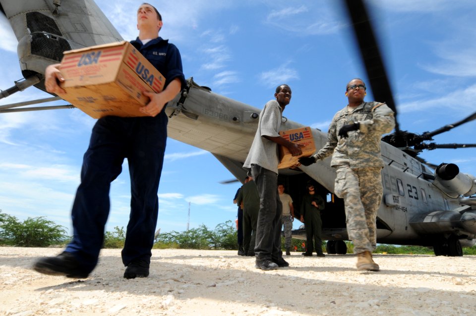 US Navy 080910-N-9774H-241 Deck Seaman Scott Polk, assigned to the amphibious assault ship USS Kearsarge (LHD 3), supplies from a CH-53 helicopter in support of humanitarian assistance relief for the people of Haiti