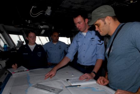 US Navy 080911-N-1635S-001 Quartermaster 3rd Class Christopher Bridges describes his job to Ultimate Fighting Championship (UFC) fighter Rich Franklin on the bridge of the Nimitz-class aircraft carrier USS Ronald Reagan (CVN 76