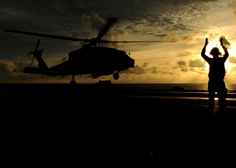 US Navy 080906-N-9898L-262 A landing signalman enlisted directs an HH-60H Sea Hawk assigned to the
