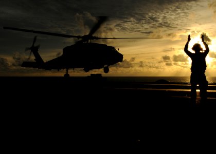 US Navy 080906-N-9898L-262 A landing signalman enlisted directs an HH-60H Sea Hawk assigned to the