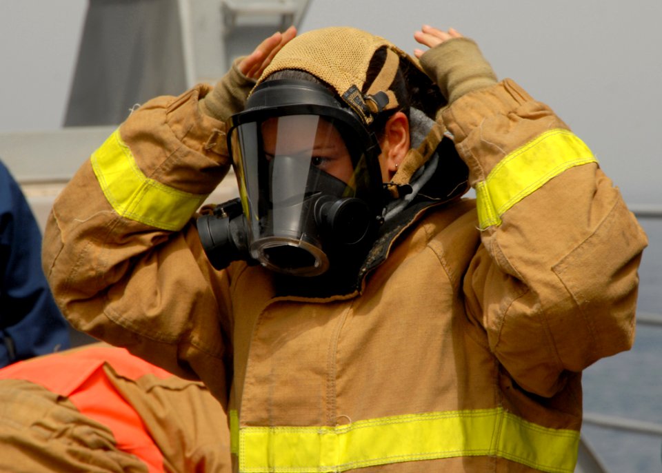 US Navy 080909-N-9134V-014 Engineman Fireman Tania Sepulveda dons her gas mask during a damage control Olympics aboard the amphibious dock landing ship USS Carter Hall (LSD 50)