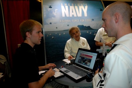 US Navy 111004-N-ZA319-021 Petty Officer 1st Class Matthew Drain provides a student at the North Carolina State University Engineering Career Fair