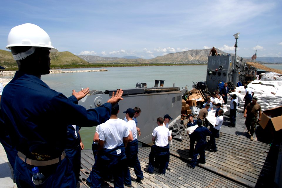 US Navy 080909-N-9620B-257 Sailors embarked aboard the amphibious assault ship USS Kearsarge (LHD 3) deliver more than 100,000 pounds of food and water for the victims of recent hurricanes that have struck Haiti