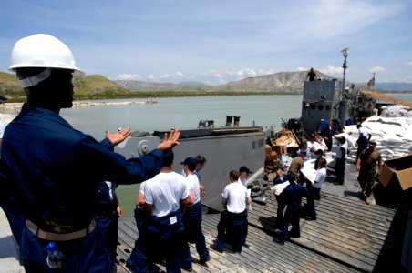 US Navy 080909-N-9620B-257 Sailors embarked aboard the amphibious assault ship USS Kearsarge (LHD 3) deliver more than 100,000 pounds of food and water for the victims of recent hurricanes that have struck Haiti