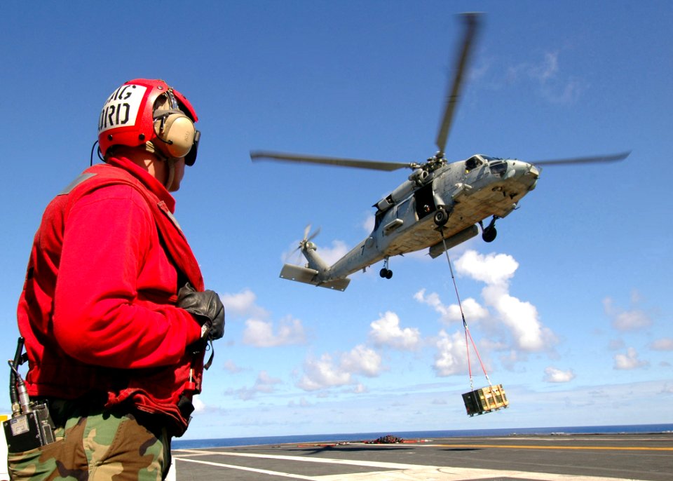 US Navy 080911-N-7282P-028 An Aviation Ordnanceman stands by as an SH-60F Sea Hawk helicopter assigned to Anti-Submarine Squadron (HS) 14, the