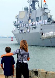 US Navy 080912-N-1688B-065 Family members of Sailors aboard the guided-missile destroyer USS Nitze (DDG 94) watch from the pier as the ship leaves for a scheduled deployment
