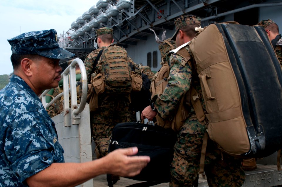 US Navy 111104-N-ER662-265 Master Chief Culinary Specialist Patricio M. Amansec directs the flow of traffic as Marines debark USS Essex