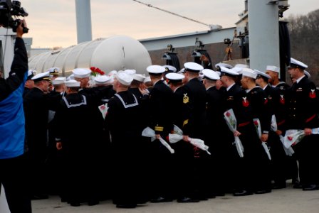 US Navy 111214-N-AW342-102 Sailors assigned to the Los Angeles-class submarine USS Dallas (SSN 700) talk before meeting with loved ones waiting on