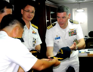 US Navy 110813-N-DB801-369 Capt. Daniel Grieco presents a command ball cap to Republic of Korean navy Capt. Lee