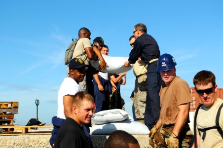 US Navy 080912-N-4515N-048 Rear Adm. Joseph Kernan, commander of the U.S. 4th Fleet, center right, helps Service members embarked aboard the amphibious assault ship USS Kearsarge (LHD 3) unload food and supplies