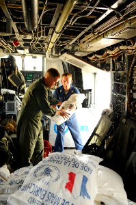 US Navy 080909-N-4515N-562 U.S. military personnel embarked aboard the amphibious assault ship USS Kearsarge (LHD 3) load supplies onto a helicopter to support hurricane relief efforts in Haiti