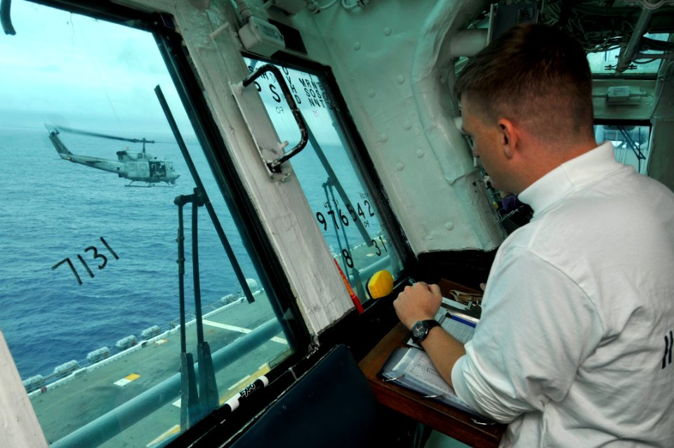 US Navy 111010-N-KM175-127 Lt. Scott Purcell, the aircraft handler aboard the forward-deployed amphibious assault ship USS Essex (LHD 2), directs f