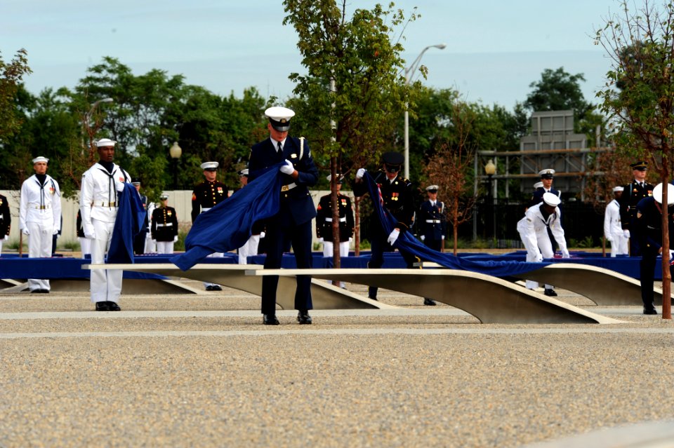 US Navy 080911-D-7203C-014 Members of an honor guard consisting of 184 joint service troops unveil the Pentagon Memorial in Washington as the United States Air Force Band plays