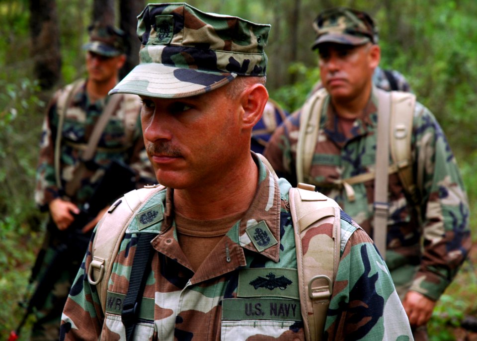 US Navy 080911-N-7367K-003 Chief Steelworker Jeffrey Wright and other Seabees receive instructions on patrolling tactics