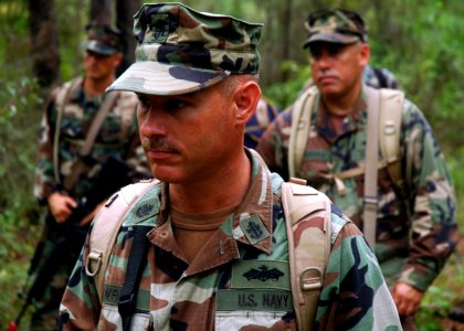 US Navy 080911-N-7367K-003 Chief Steelworker Jeffrey Wright and other Seabees receive instructions on patrolling tactics