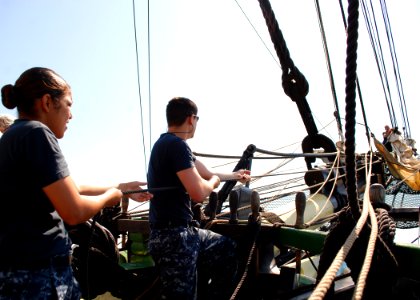 US Navy 110715-N-AU127-226 Sailors assigned to USS Constitution heave a line during sail training aboard Friendship of Salem
