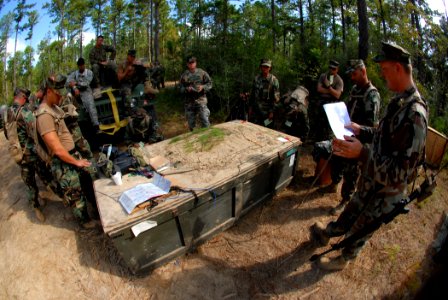 US Navy 080911-N-7367K-011 Builder 1st Class Matthew Martini gives his squad a patrol brief photo